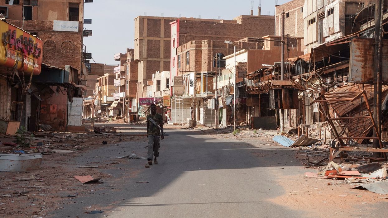 A member of the Sudanese Armed forces walks between damaged buildings, almost one year into the war between the Sudanese Armed Forces and the paramilitary Rapid Support Forces (RSF), in Omdurman, Sudan, April 7, 2024.