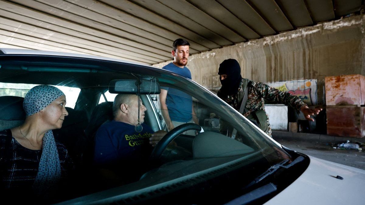 ​A member of the Syrian security forces gestures next to a vehicle at the entrance of the Druze town of Jaramana, following deadly clashes southeast of Damascus, Syria, on April 29, 2025.