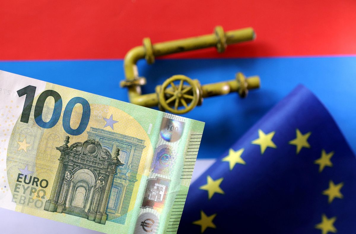 A model of a natural gas pipeline, a Euro banknote and a torn EU flag placed on a Russian flag. 