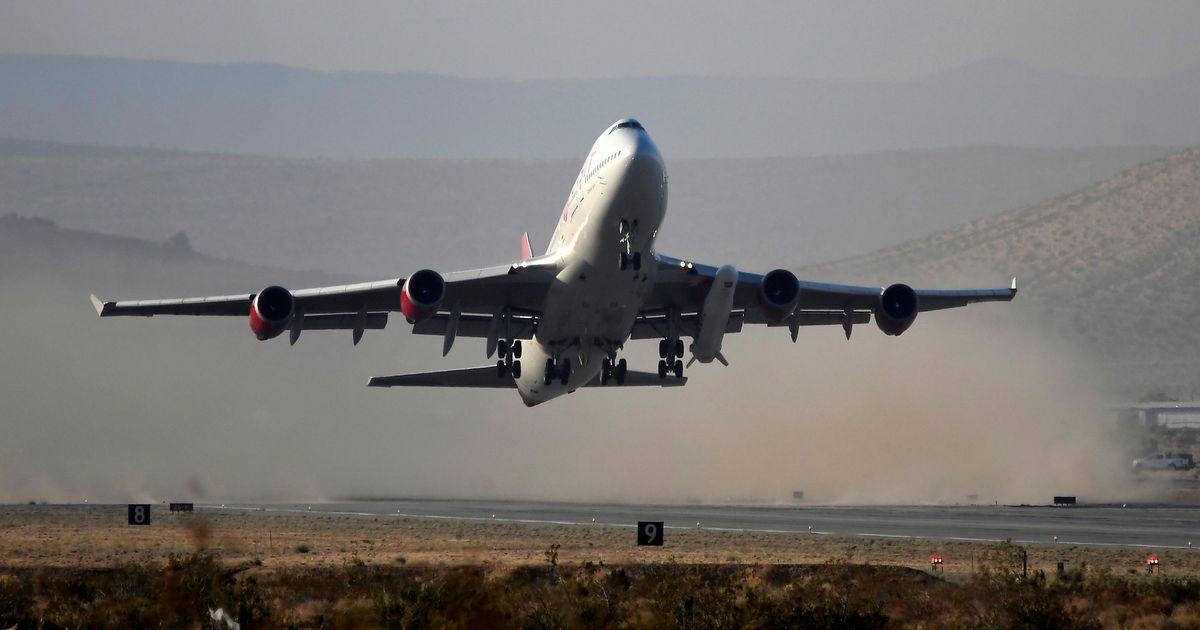 A modified Boeing 747 takes off carrying Virgin Orbit's LauncherOne rocket, in Mojave, California