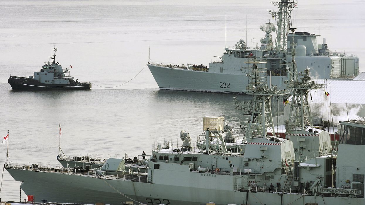 A navy tug pulls the destroyer HMCS Athabascan (top) into its dock at CFB Halifax in Nova Scotia.