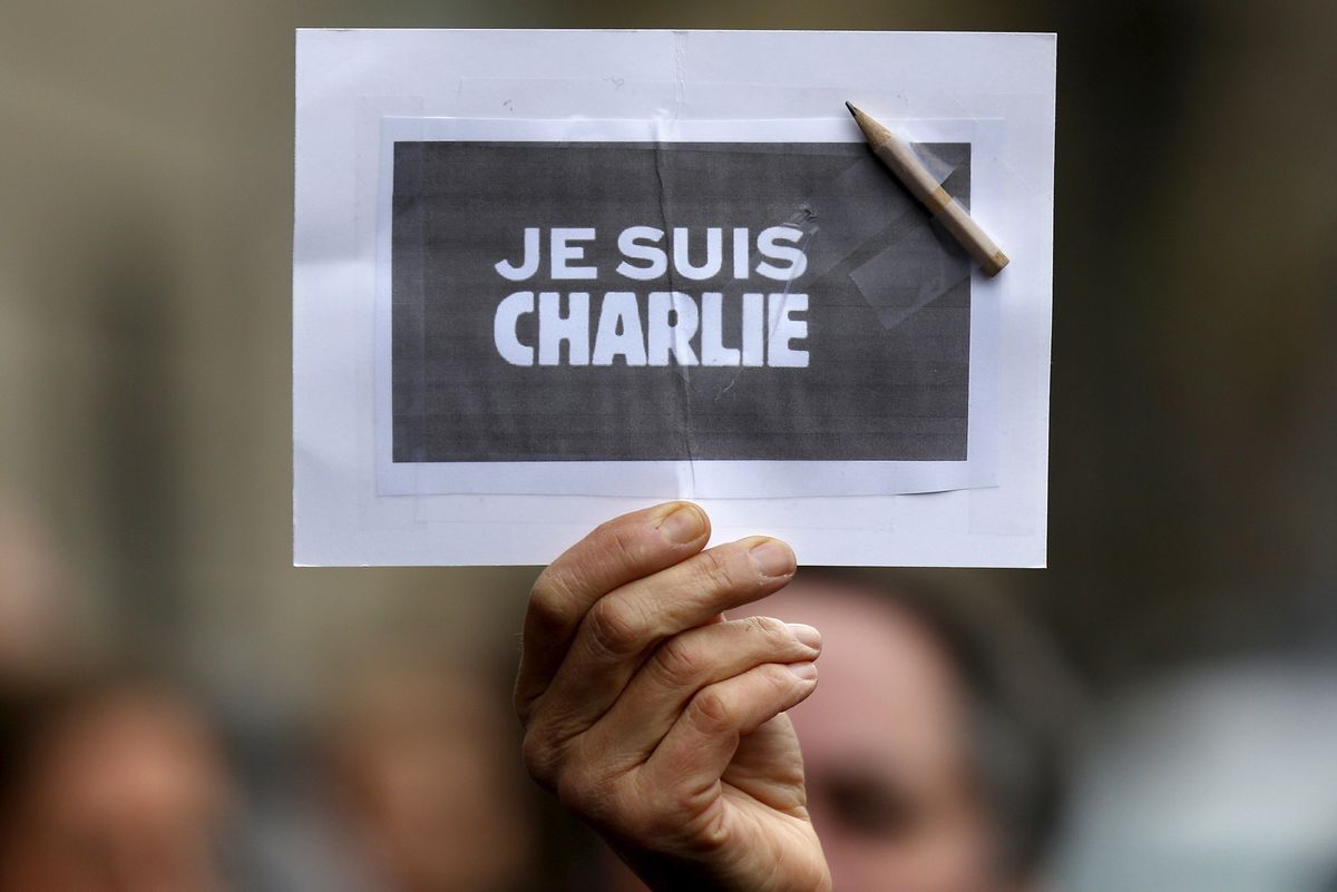 A person holds a placard with a pencil which reads "I am Charlie" during a minute of silence in Strasbourg for victims of the shooting at the Paris offices of Charlie Hebdo.