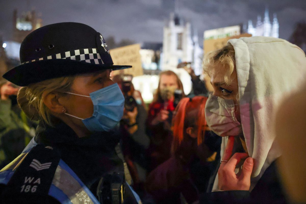 A person stands in front of a police officer at the Parliament Square, following the kidnap and murder of Sarah Everard, in London, Britain March 14, 2021.