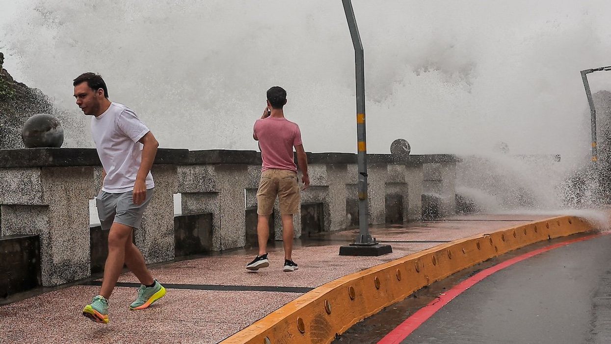 A person takes photos of the waves as Typhoon Krathon approaches in Kaohsiung, Taiwan October 2, 2024.