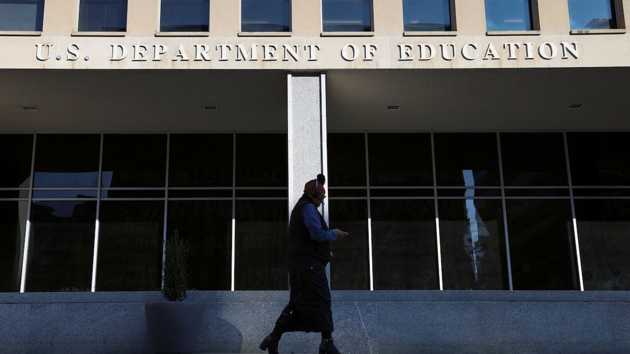A person walks in front of the Department of Education building in Washington, DC, on Feb. 4, 2025.