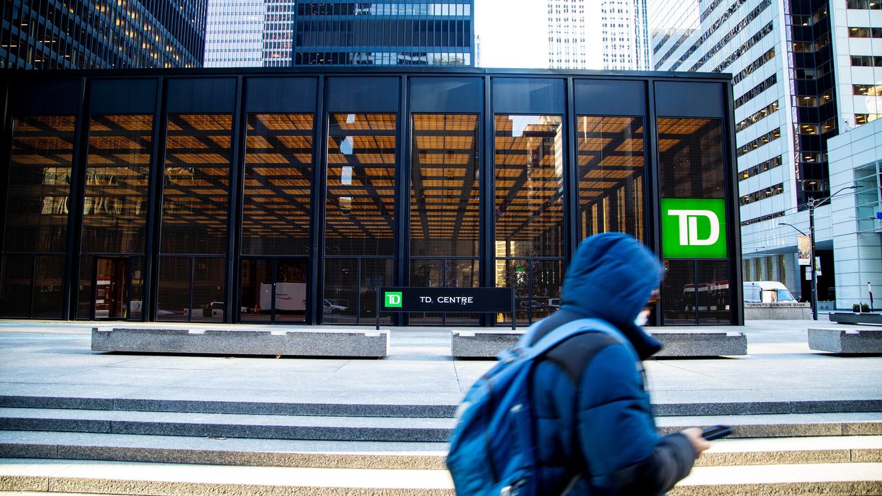 A person walks past a sign for TD Canada Trust in Toronto, Ontario.