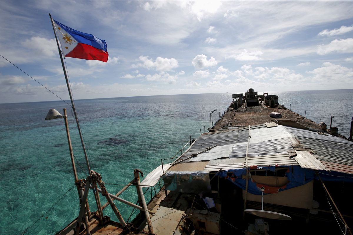 A Philippine flag flutters from a Philippine Navy ship