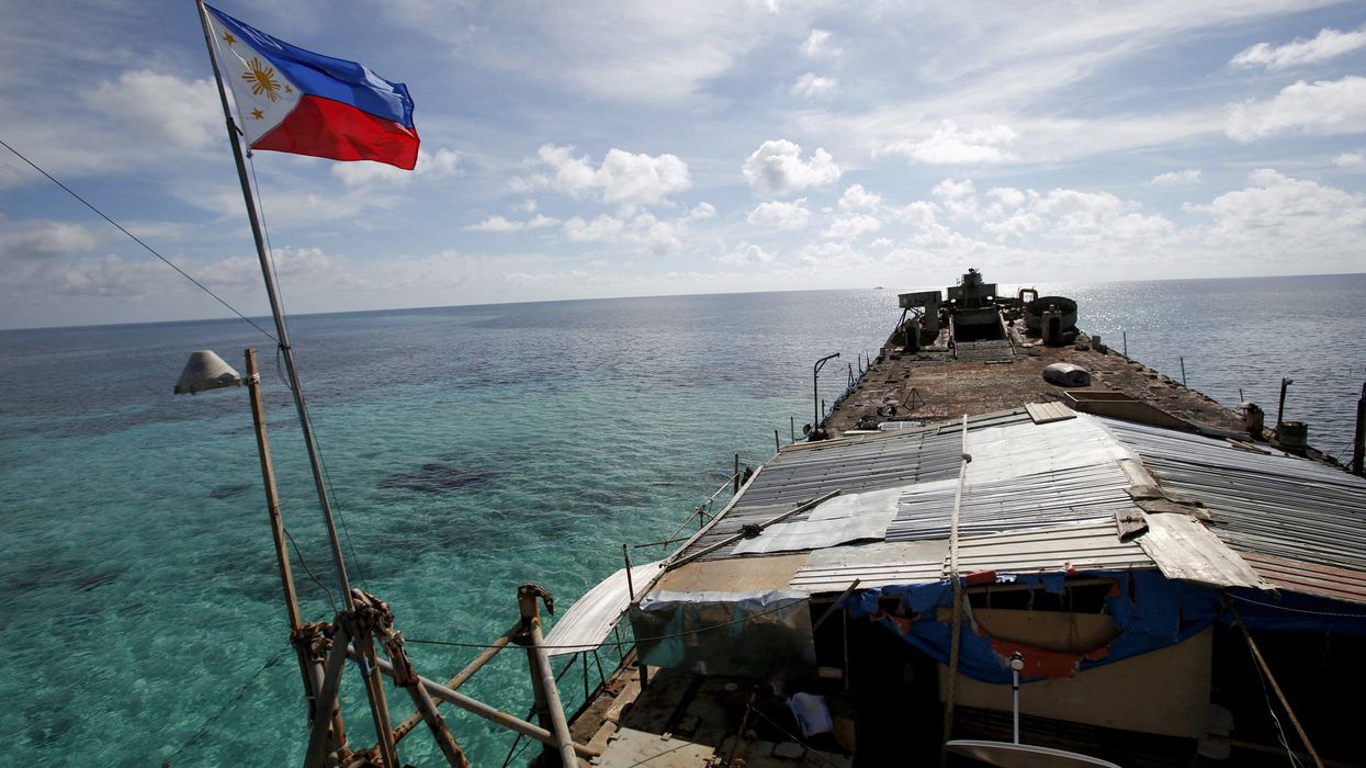 A Philippine flag flutters from BRP Sierra Madre, a dilapidated Philippine Navy ship that has been aground since 1999 and became a Philippine military detachment on the disputed Second Thomas shoal in the South China Sea.