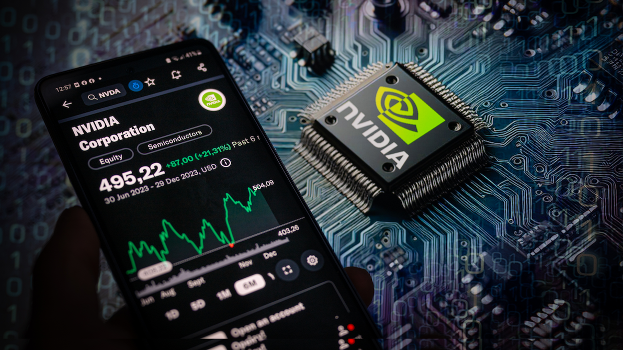 A photo illustration of a smartphone displaying the NVIDIA Corporation stock price on the NASDAQ market, with an NVIDIA chip visible in the background.