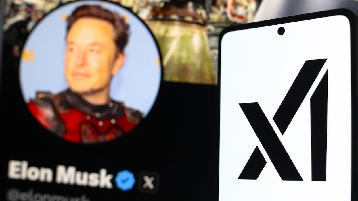 A photo illustration with the xAI logo displayed on a smartphone with the official profile of Elon Musk in the background.
