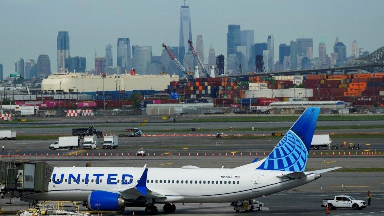 A plane docks on the tarmac after an air traffic control outage brings flights to a standstill at Newark Liberty International Airport in Newark, New Jersey, USA, on May 12, 2025. 