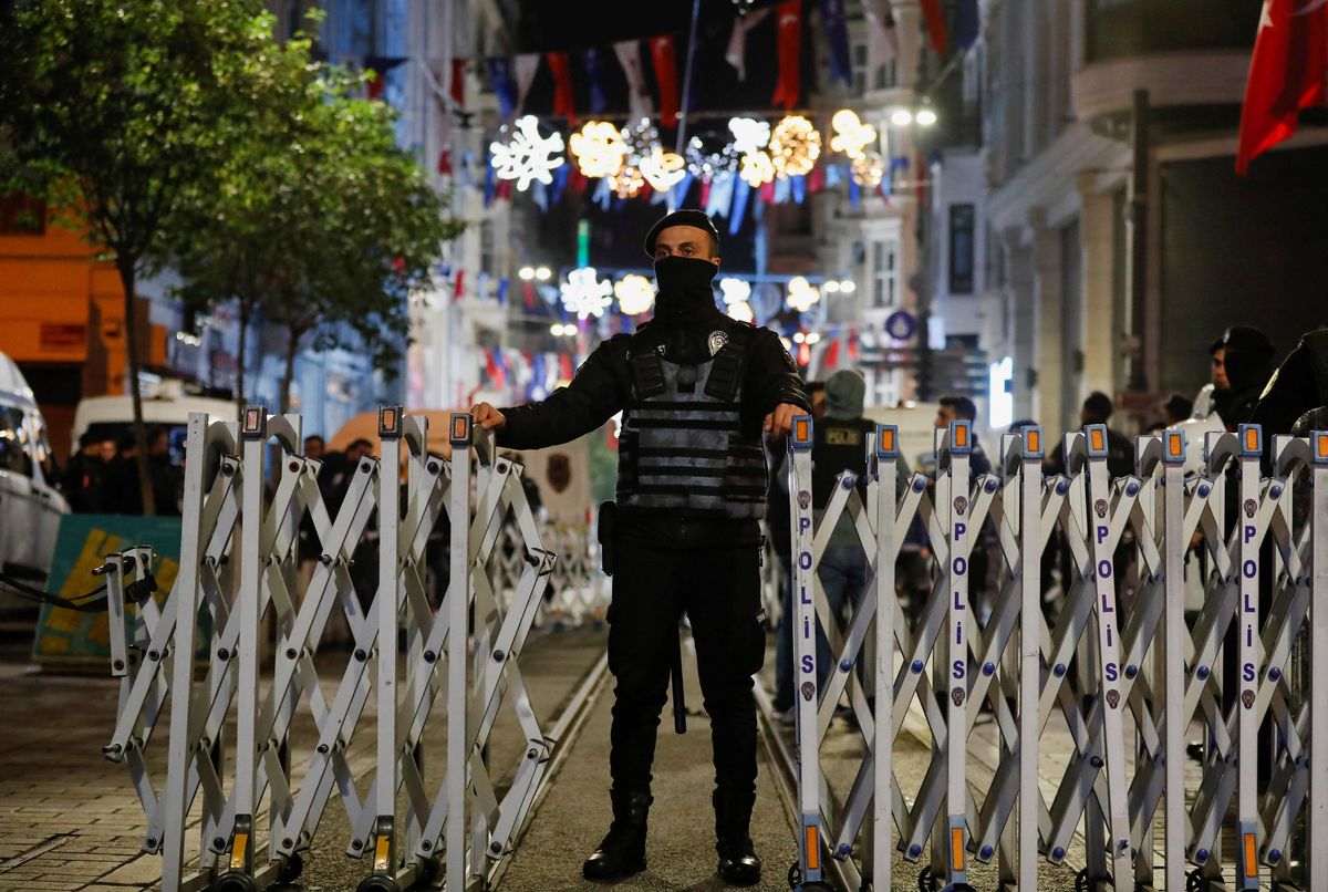 A police officer blocks the street after an explosion on busy pedestrian Istiklal street in Istanbul, Turkey.