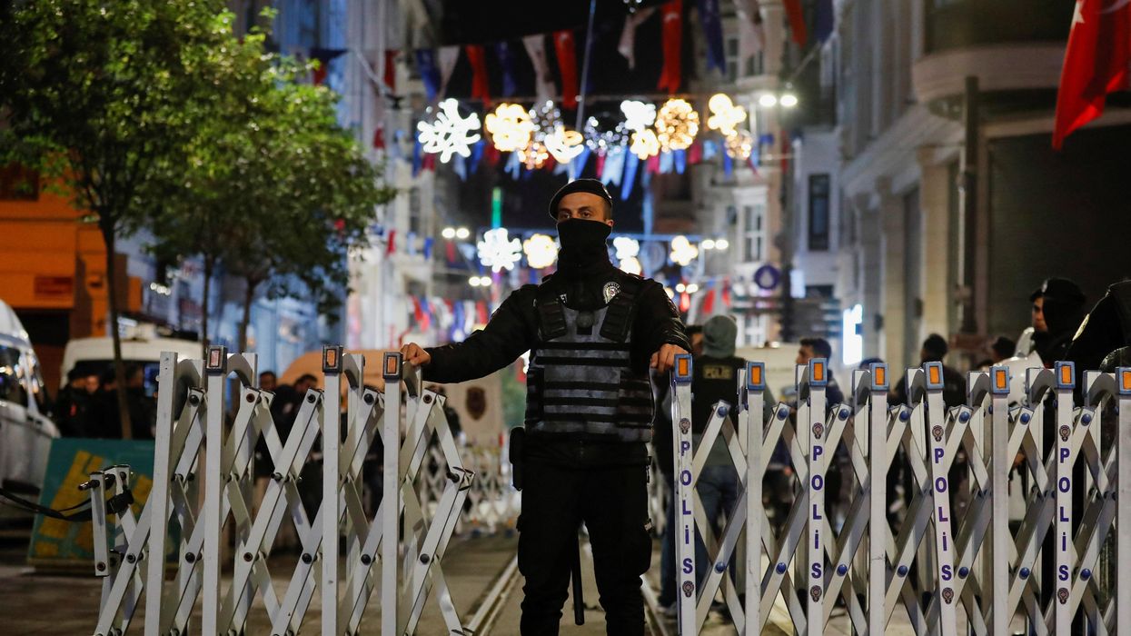 A police officer blocks the street after an explosion on busy pedestrian Istiklal street in Istanbul, Turkey.