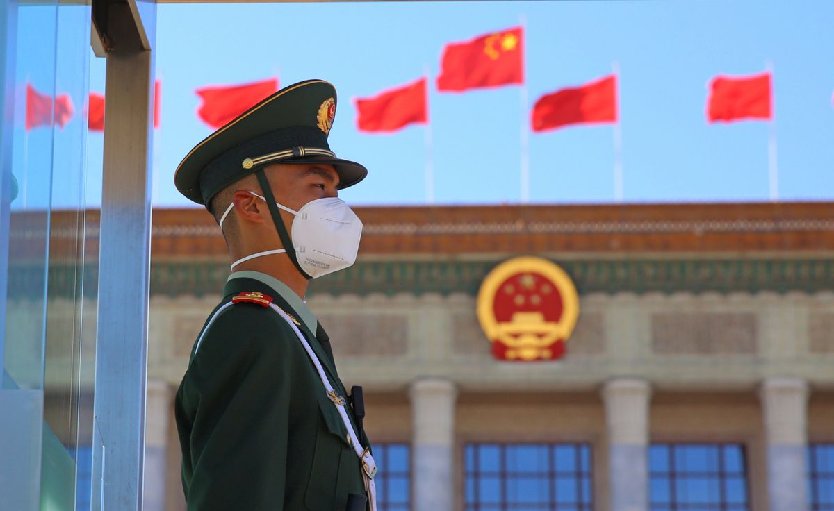 A police officer stands at the Great Hall of the People in Beijing.