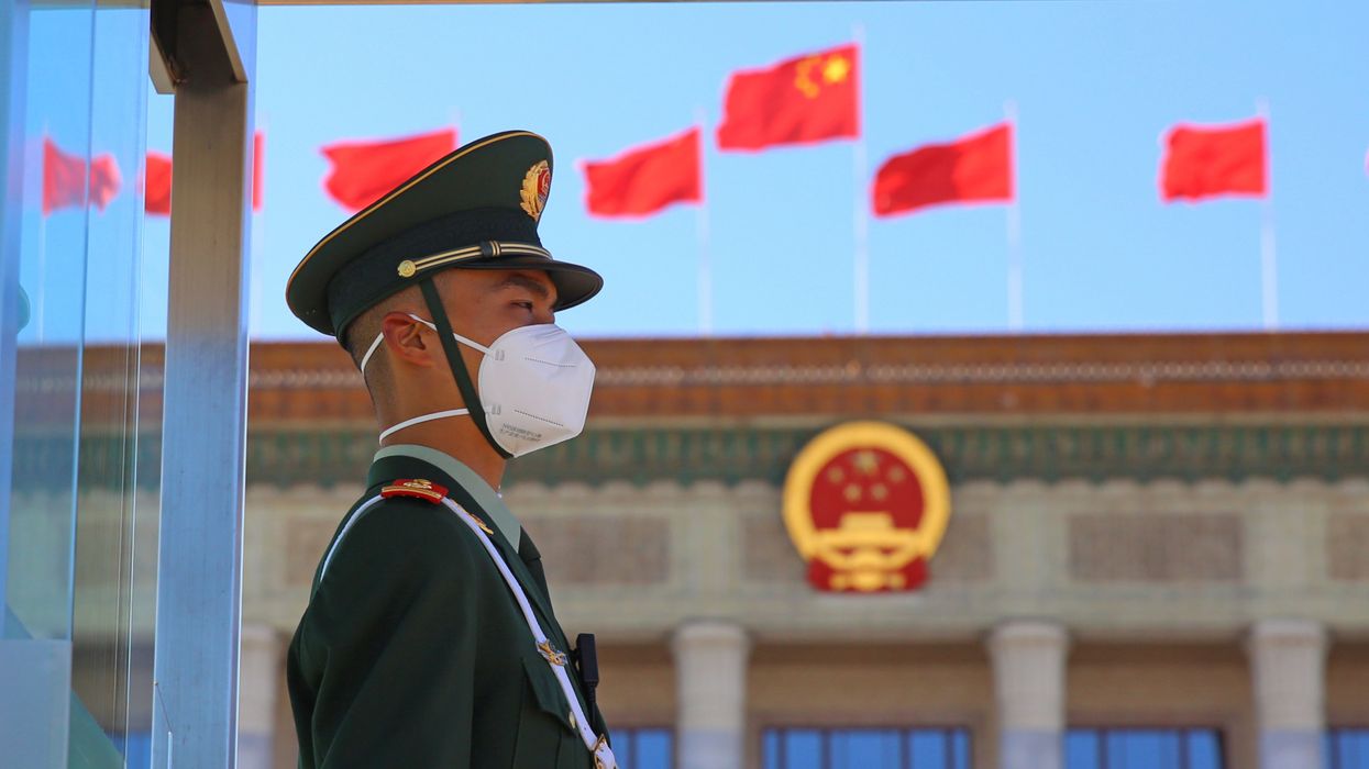 A police officer stands at the Great Hall of the People in Beijing.