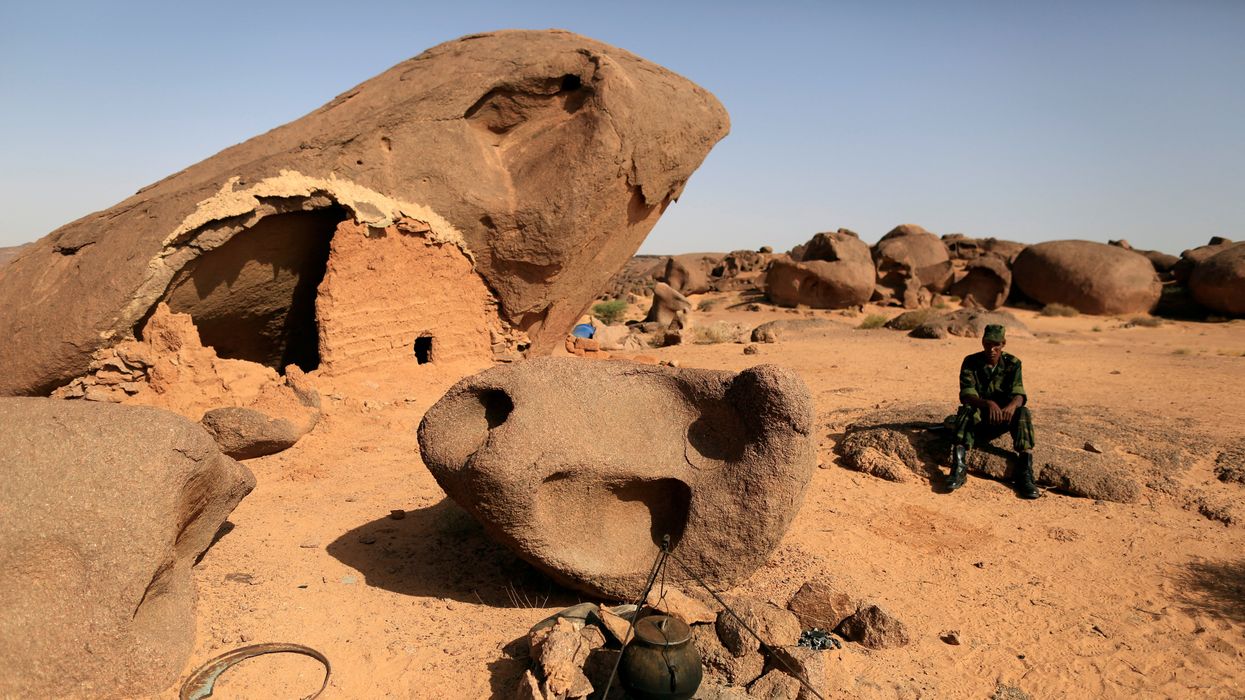 A Polisario fighter sits on a rock at a forward base on the outskirts of Tifariti, Western Sahara, September 9, 2016.