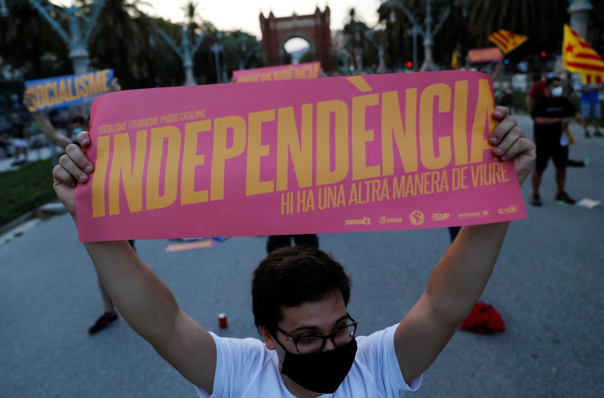 A pro-independence protester holds a placard that reads: "Independence. There's another way to live", during a demonstration on Catalonia's day of 'La Diada' in Barcelona, Spain, September 11, 2020