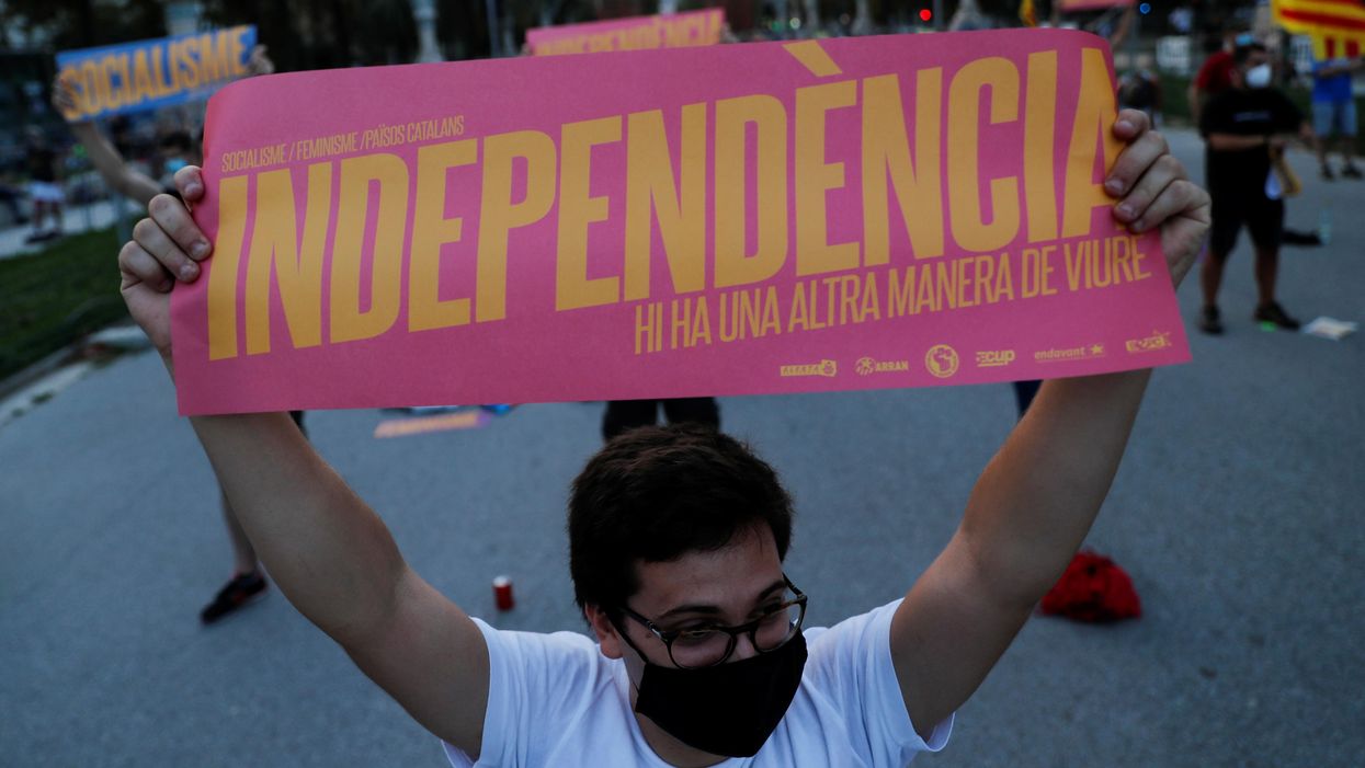 A pro-independence protester holds a placard that reads: "Independence. There's another way to live", during a demonstration on Catalonia's day of 'La Diada' in Barcelona, Spain, September 11, 2020
