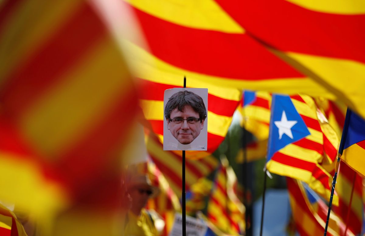 A protester holds a portrait of former Catalan President Carles Puigdemont during a protest in front of the European Parliament in Strasbourg, France. 