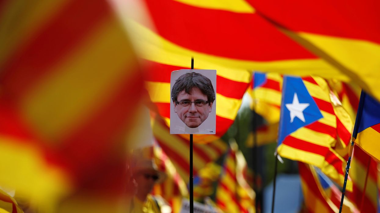 A protester holds a portrait of former Catalan President Carles Puigdemont during a protest in front of the European Parliament in Strasbourg, France.