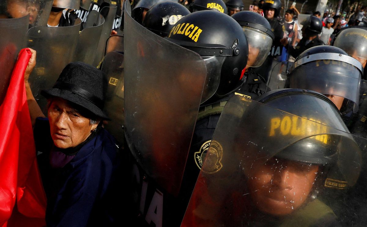 A protester interacts with police during a demonstration against Peru's President Dina Boluarte in January 2023. 