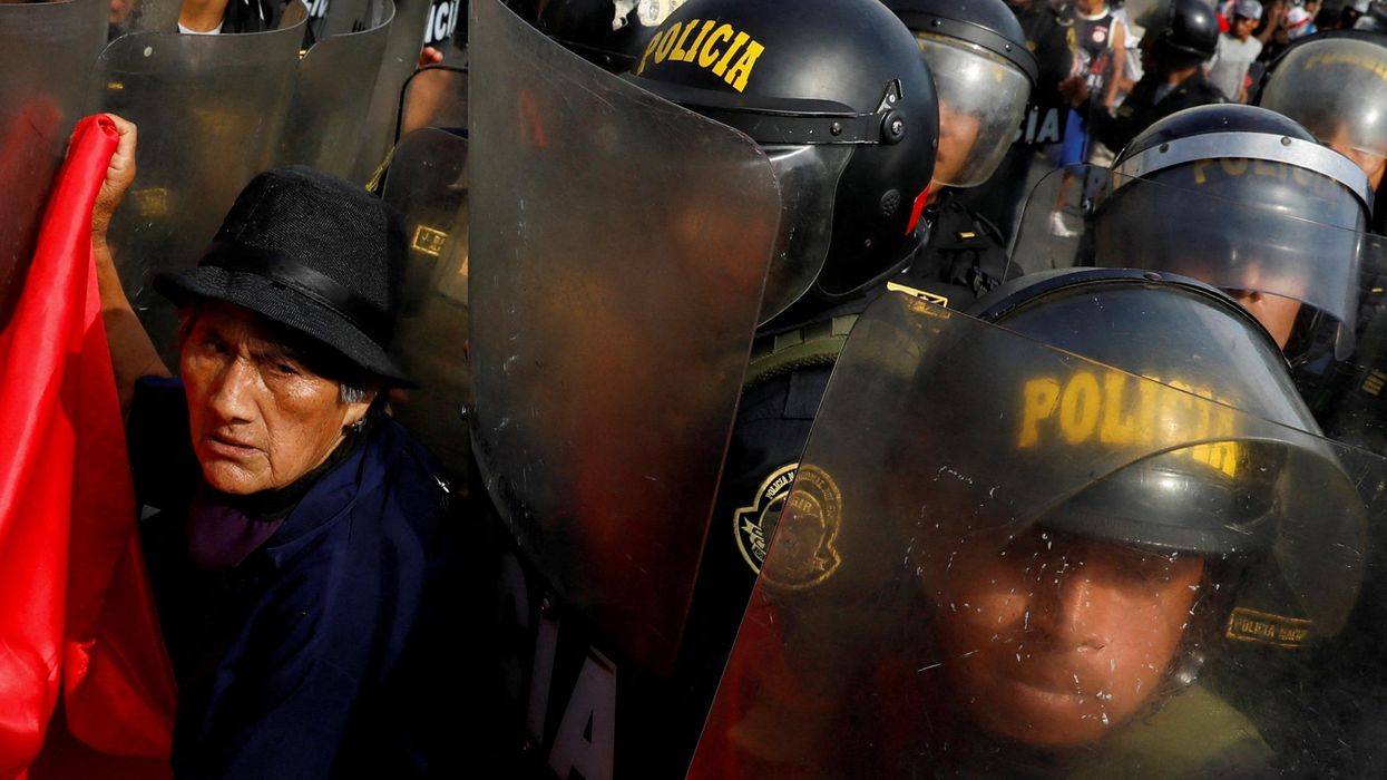 A protester interacts with police during a demonstration against Peru's President Dina Boluarte in January 2023.
