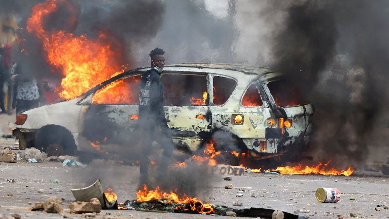 A protester looks on near a burning barricade during a "national shutdown" against the election outcome, in Maputo, Mozambique, on Nov. 7, 2024.