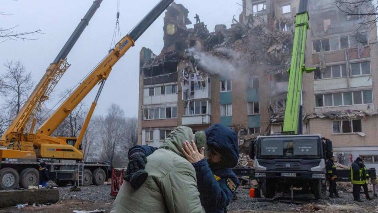 A psychologist comforts a resident in front of an apartment building that was hit yesterday by a Russian missile, amid Russia's attack on Ukraine, in Ternopil, Ukraine, November 20, 2025.