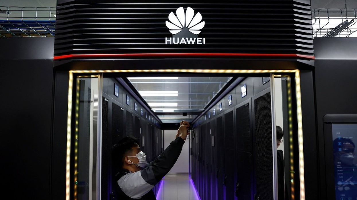 A reporter films at a data centre supported by Huawei, at Hongliulin Coal Mine during a Huawei-organised media tour, in Shenmu of Yulin city, Shaanxi province, China April 25, 2023.