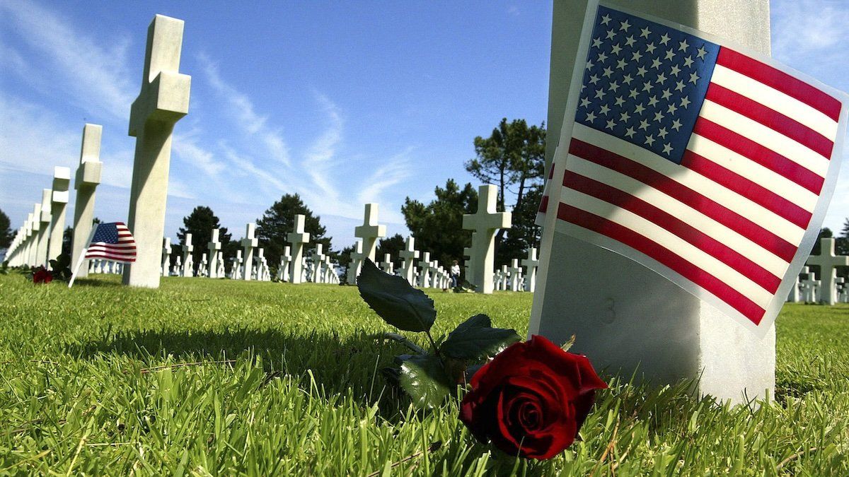 A rose lies near the grave marker of an American soldier at the Colleville-sur-Mer war cemetery near Omaha Beach in Normandy, northern France.