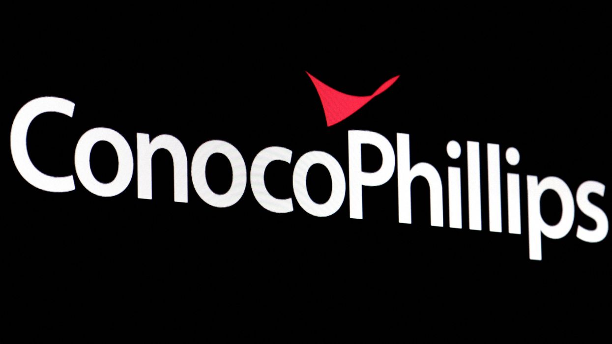 A screen displays the logo for ConocoPhillips on the floor of the New York Stock Exchange.