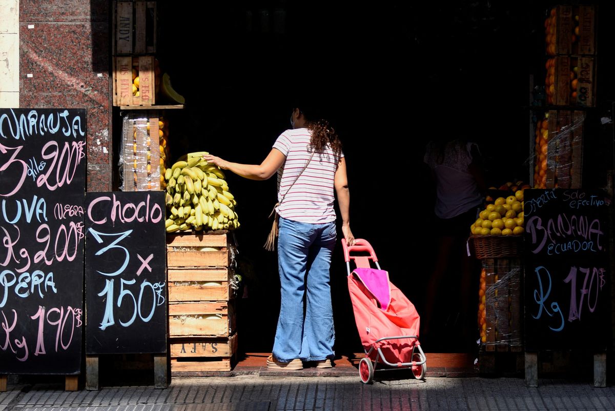 A shopper looks at produce in a market in Buenos Aires, Argentina. 