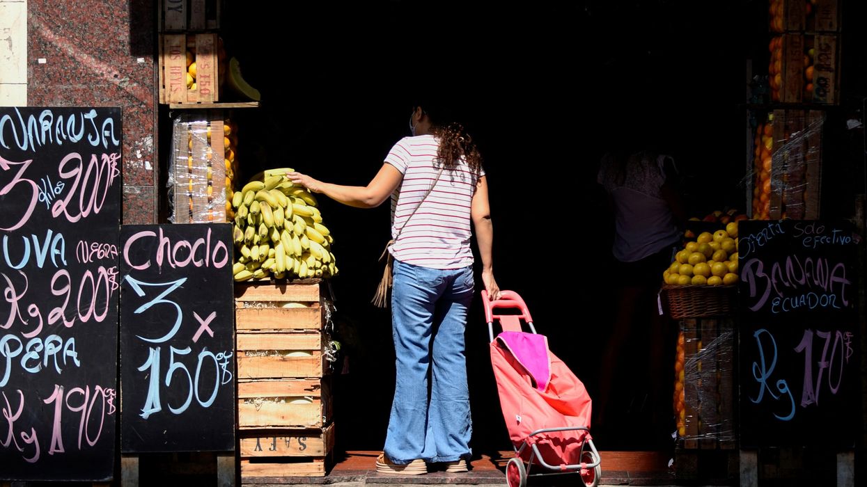 A shopper looks at produce in a market in Buenos Aires, Argentina.