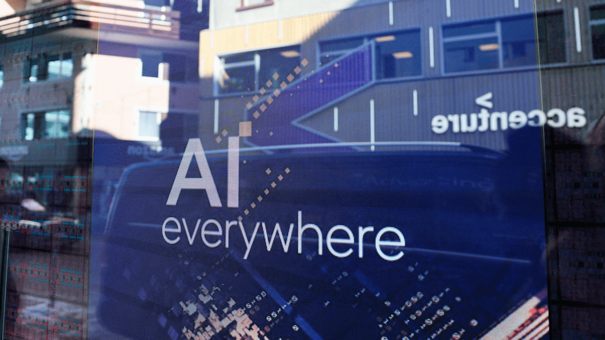 A slogan related to Artificial Intelligence is displayed on a screen in the Intel pavilion during the 54th annual meeting of the World Economic Forum in Davos, Switzerland.