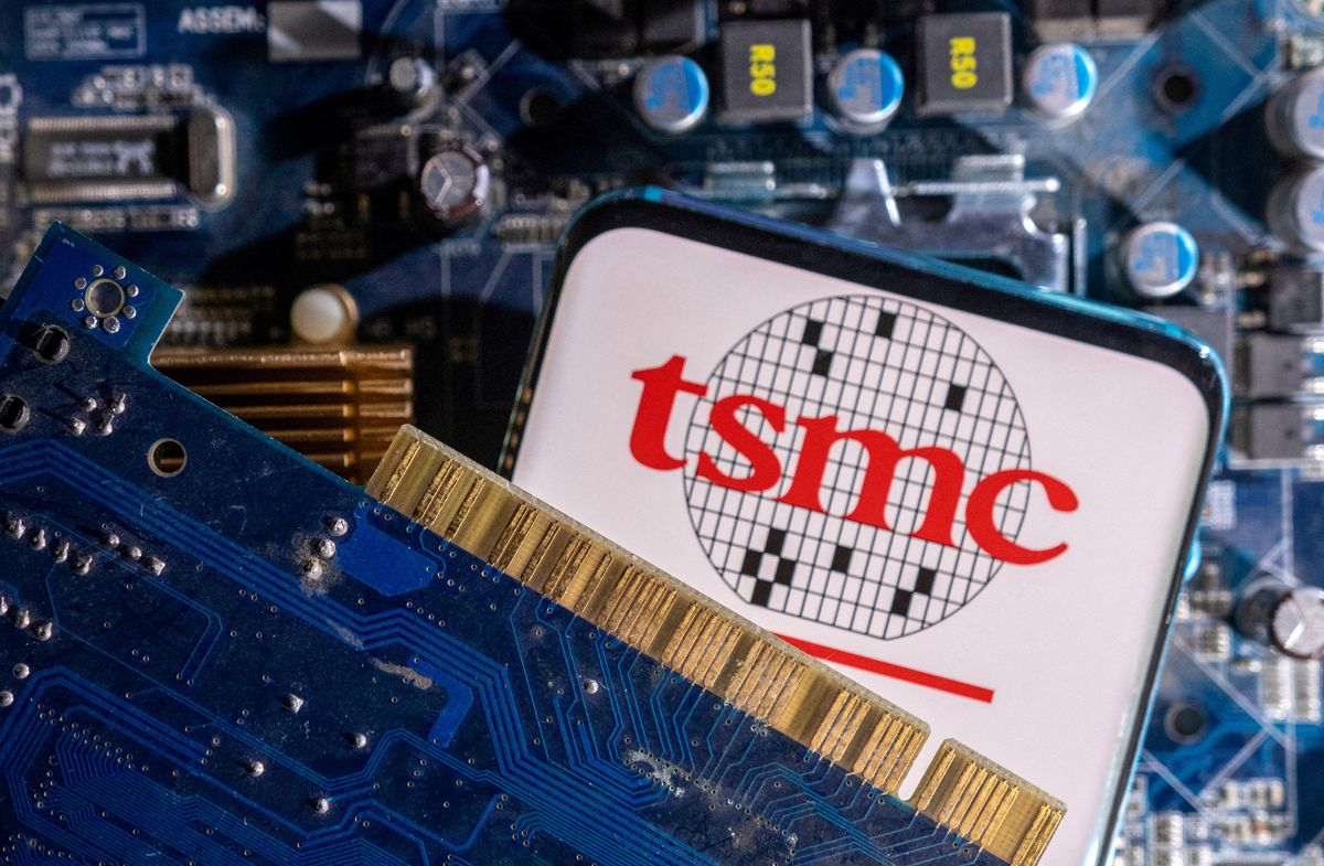 ​A smartphone with a displayed TSMC (Taiwan Semiconductor Manufacturing Company) logo is placed on a computer motherboard in this illustration taken March 6, 2023. 