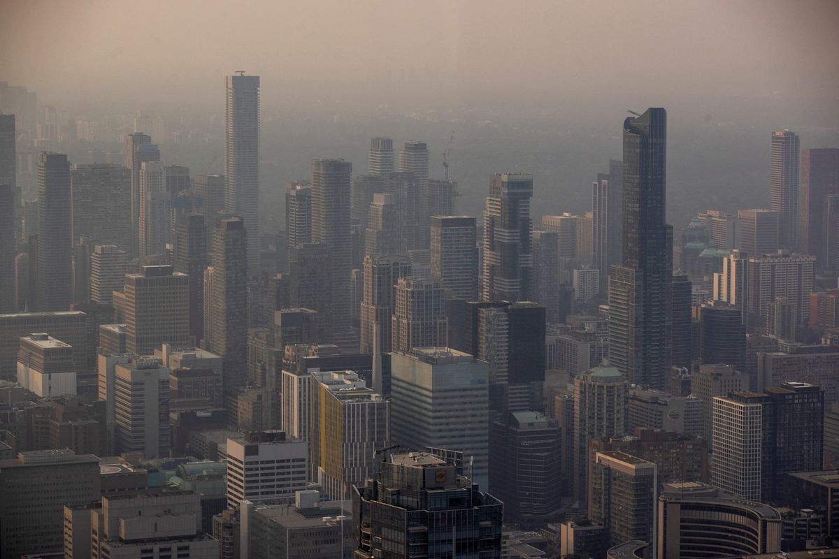 A smoky Toronto skyline is seen from the CN Tower as wildfires in Ontario and Quebec continue to burn.