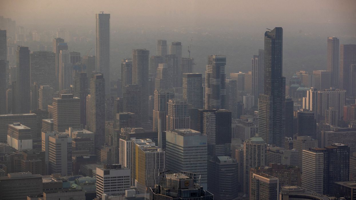 A smoky Toronto skyline is seen from the CN Tower as wildfires in Ontario and Quebec continue to burn.
