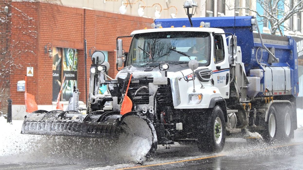 A snow plow clears the road along Main Street in downtown Brampton, Ontario, on Jan. 2, 2025.