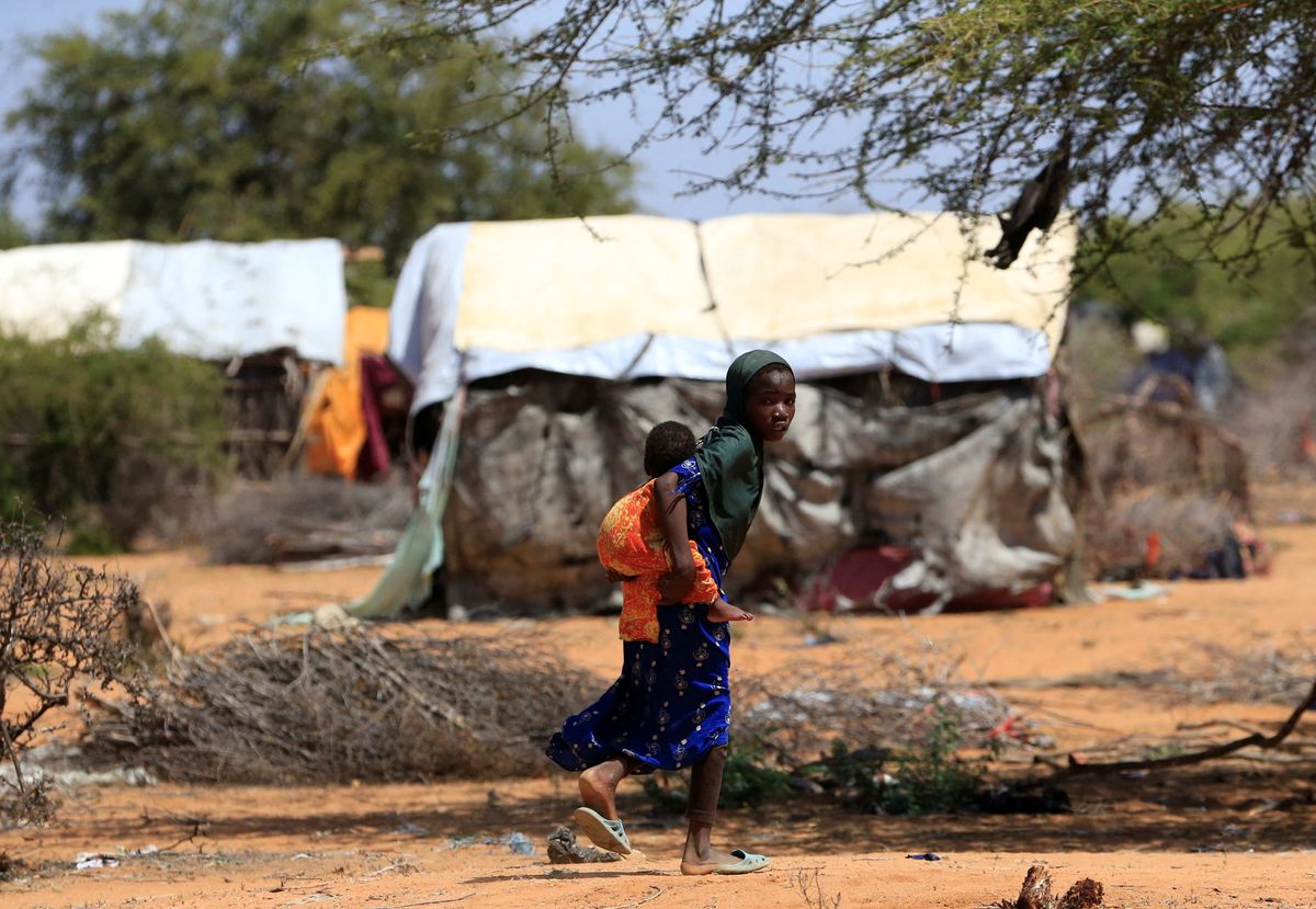 ​A Somali refugee girl carries her sibling in the Hagadera refugee camp near the Kenya-Somalia border, in Garissa County, Kenya, January 17, 2023.