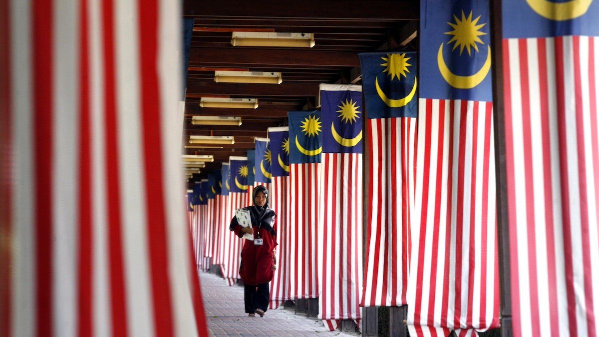 A student of National University of Malaysia walks past displays of the country's "Stripes of Glory" flags at its campus in Bangi outside Kuala Lumpur August 22, 2007.