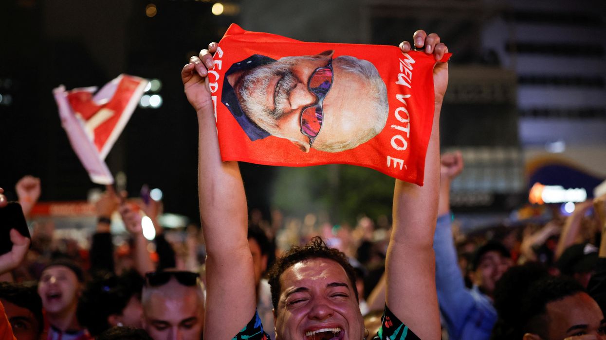 A supporter of former President Luiz Inacio Lula da Silva reacts as people gather after polling stations were closed in the presidential election in Sao Paulo, Brazil.