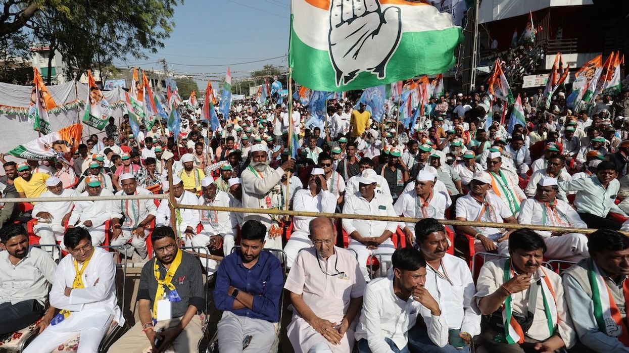 A supporter of Rahul Gandhi, a senior leader of India's main opposition Congress party, waves a party flag in a public meeting during Rahul's 66-day long "Bharat Jodo Nyay Yatra," or Unite India Justice March, in Jhalod town, Gujarat state, India, in March 2024.