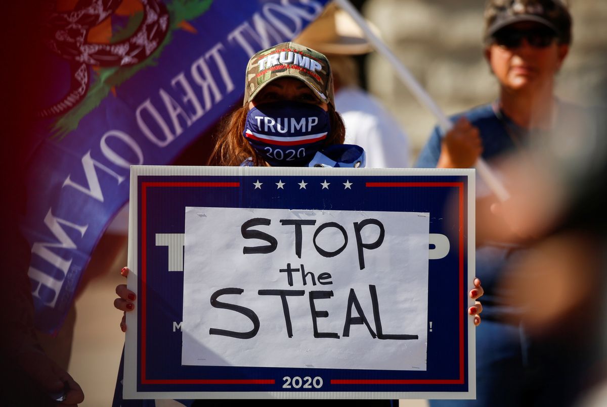 A supporter of U.S. President Donald Trump holds a sign during a “Stop the Steal” protest after the 2020 U.S. presidential election was called for Democratic candidate Joe Biden, in front of the Arizona State Capitol in Phoenix, Arizona
