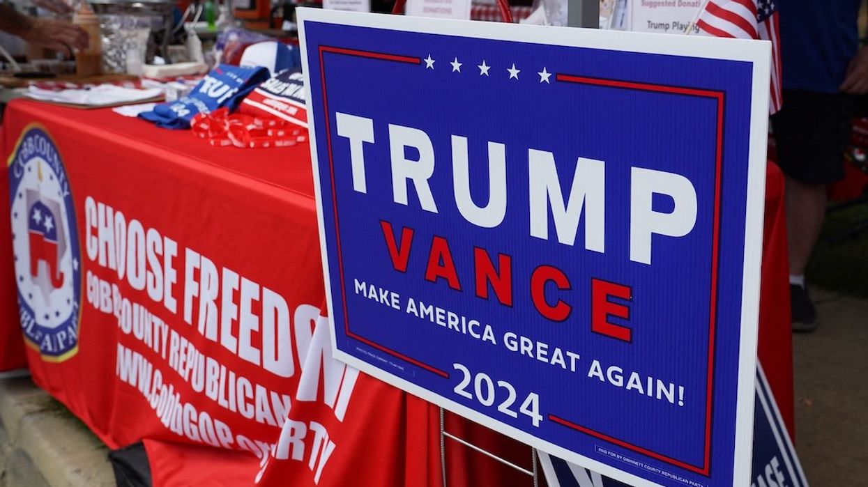 A Trump Vance campaign sign sits at the Cobb County Republican Party's booth at the Pigs and Peaches Country Festival in Kennesaw, Georgia, on Aug. 17, 2024.