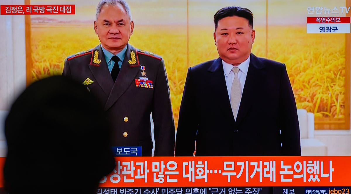 A TV screen shows an image of North Korean leader Kim Jong Un with Russian Defense Minister Sergei Shoigu in Pyongyang.