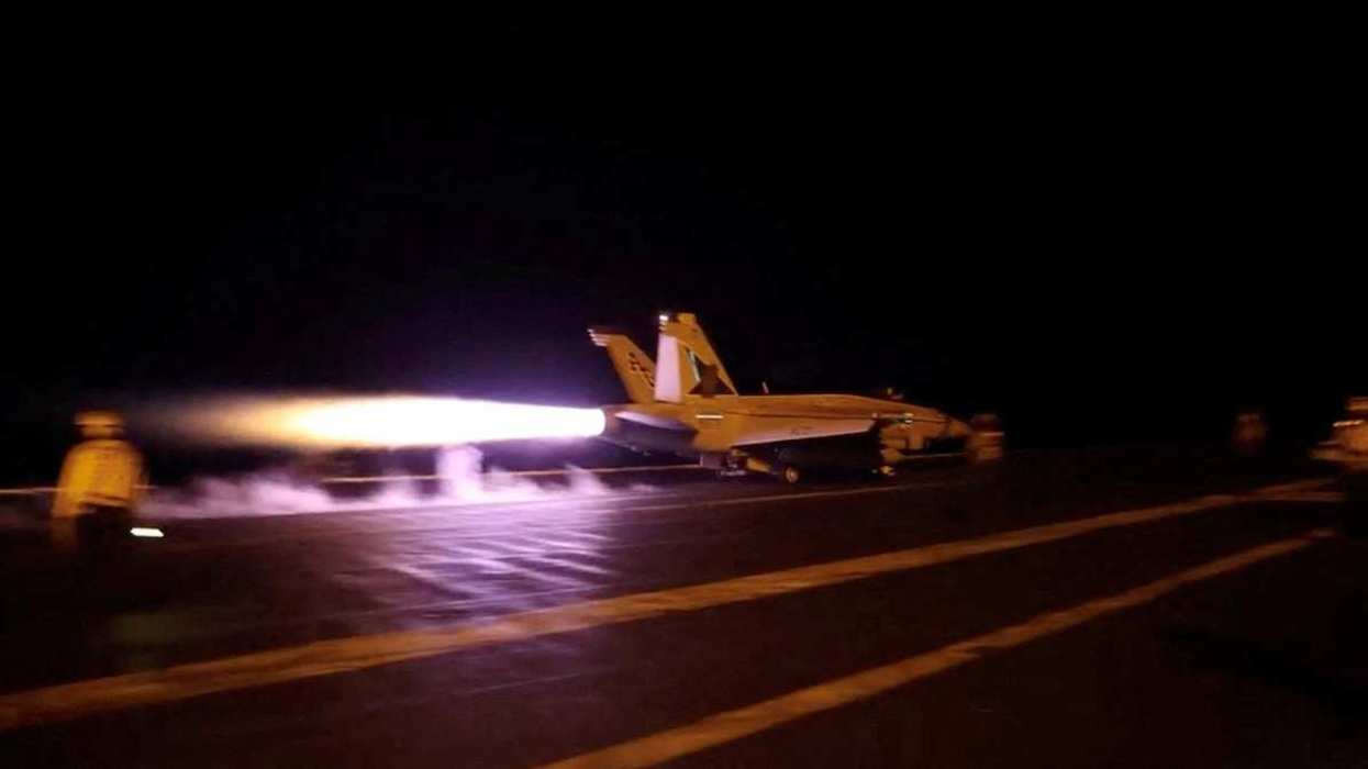 A U.S. military aircraft takes off from an unknown location