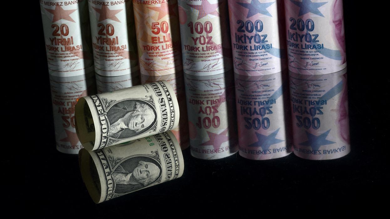 A U.S. one dollar banknote is seen next to Turkish lira banknotes in this picture illustration in Istanbul, Turkey, November 23, 2021