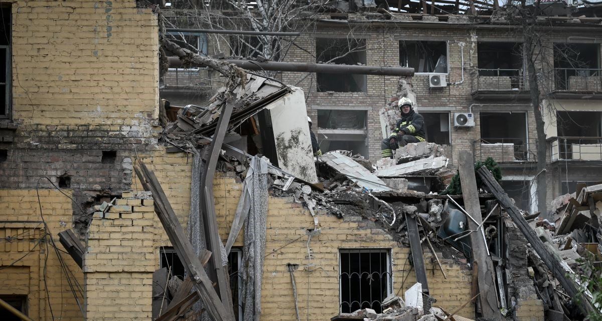 ​A Ukrainian rescue worker sits atop the rubble of a destroyed residential building during rescue operations, following a Russian missile strike on a residential apartment building block in Kyiv, Ukraine, on April 24, 2025.