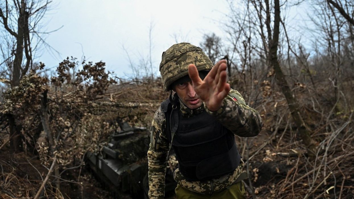 A Ukrainian serviceman gestures next to a 2S1 Gvozdika self-propelled howitzer before firing toward Russian troops, amid Russia's attack on Ukraine, at a position on a front line in Zaporizhzhia region, Ukraine November 15, 2023