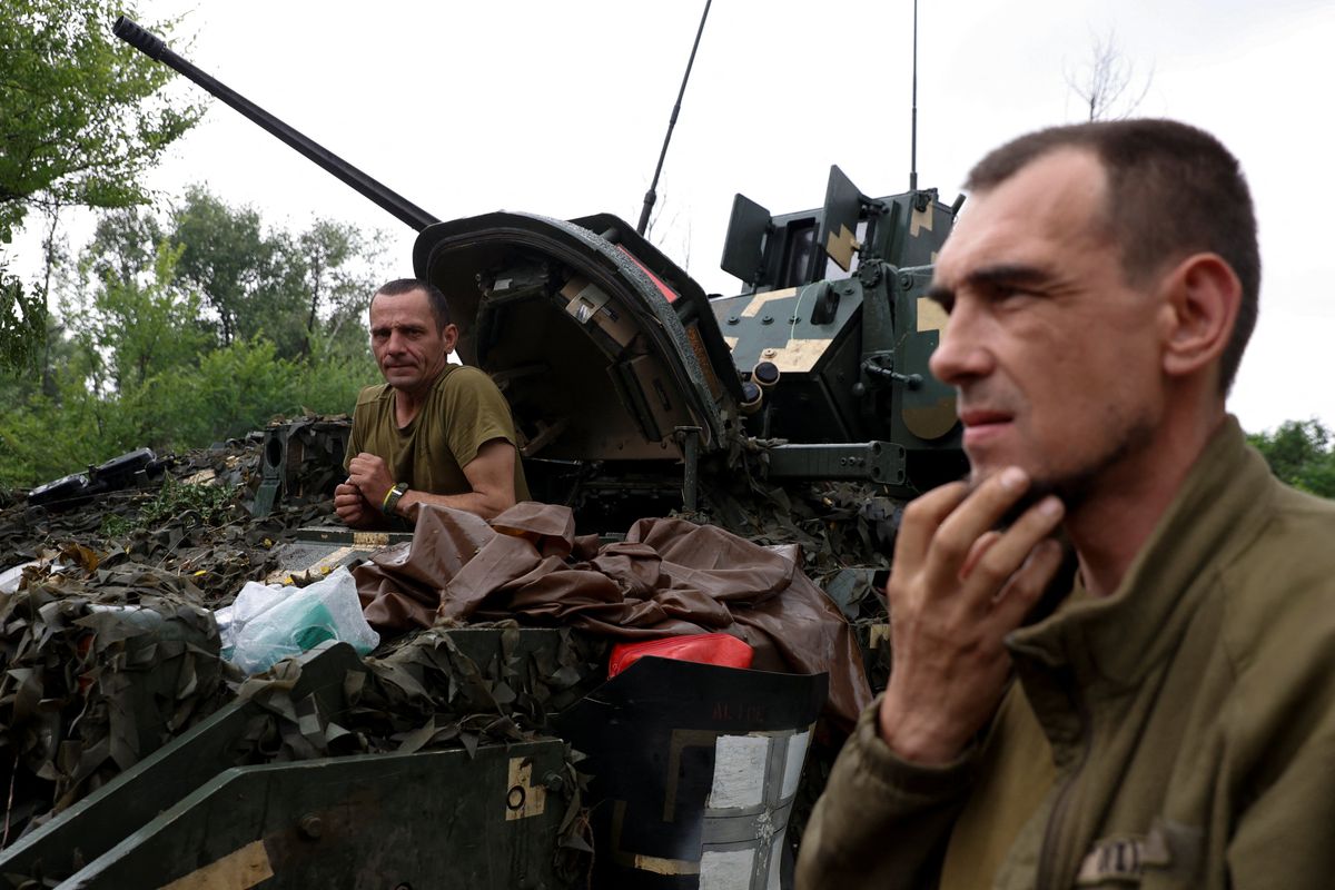 A Ukrainian serviceman of the 47th Magura Separate Mechanized Brigade sits inside a M2 Bradley infantry fighting vehicle